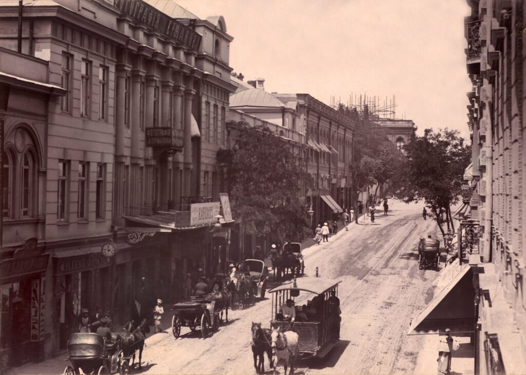 Historic view of Golovin Prospect in Tiflis with horse tram, carriages, and pedestrians, late 19th century.
